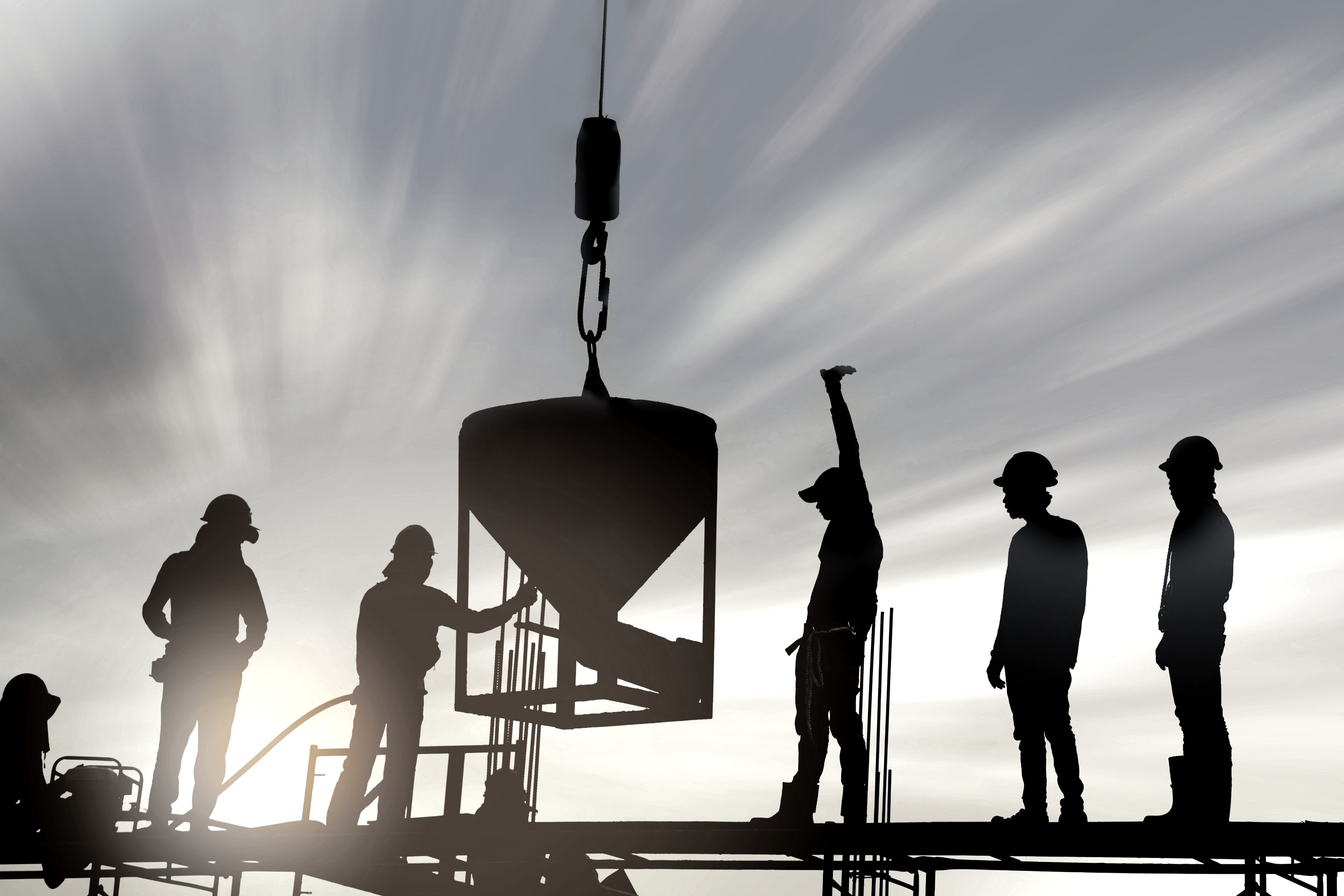 Crane lifting construction material at a project site